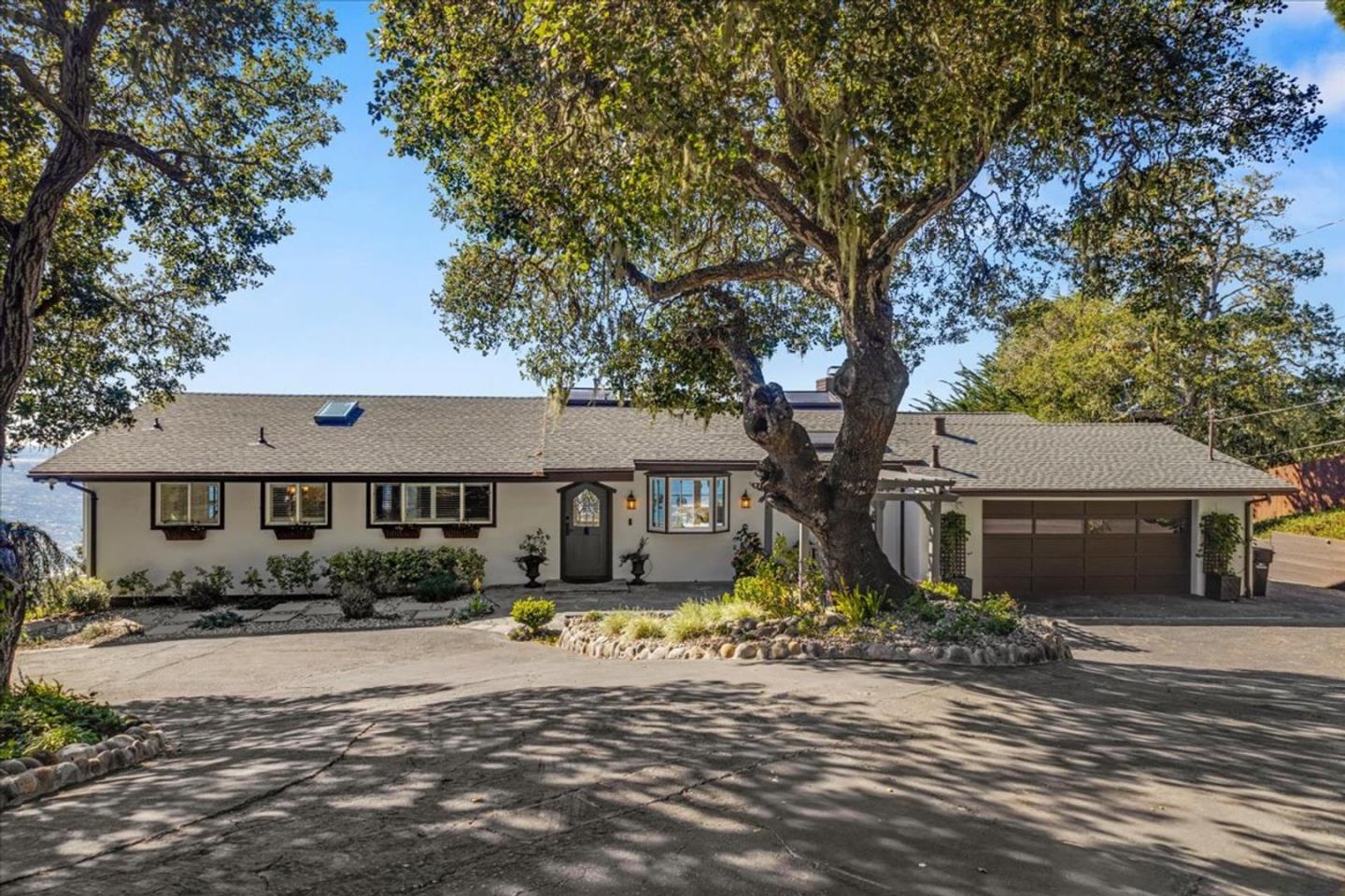 15 Mentone Road Carmel, CA 93923 - Photo 2 of 47 front view of a house with a small yard