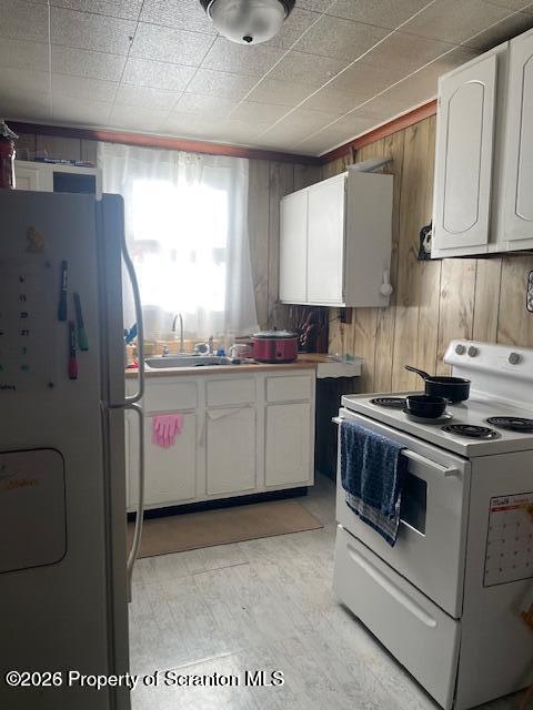 812 Butler Street Dunmore, PA 18512 - Photo 6 of 15 a kitchen with stainless steel appliances a sink a stove a refrigerator cabinets and a window