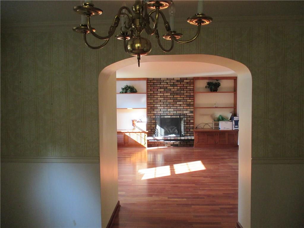 From the formal dining room you can see the large family room with fireplace