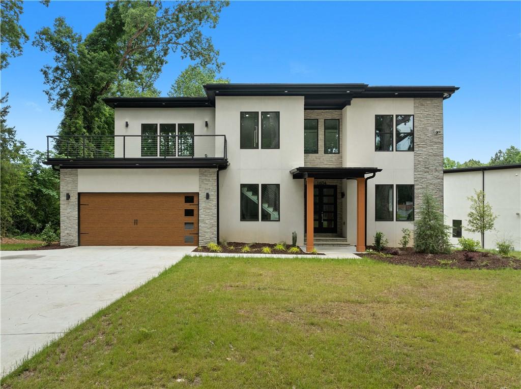 1604 Niskey Lake Road Southwest Atlanta, GA 30331 - Photo 1 of 1 a front view of a house with a yard and garage