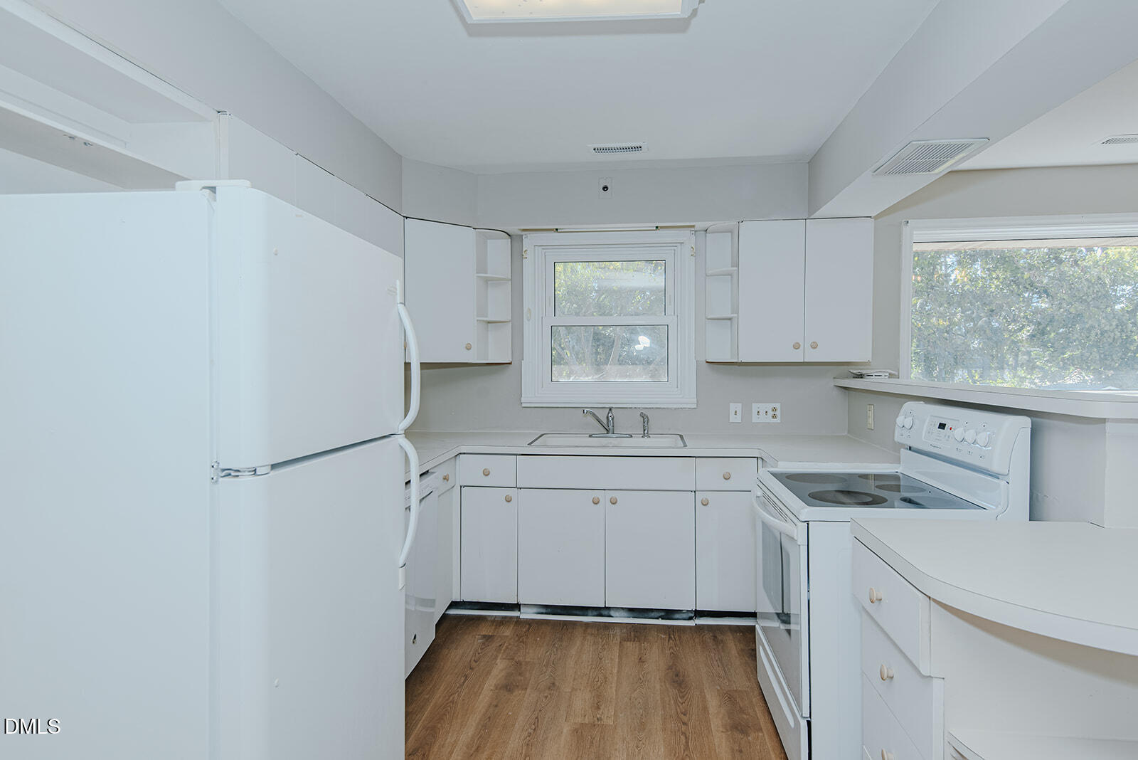 408 Ward Street Graham, NC 27253 - Photo 12 of 21 a kitchen with a sink a stove a refrigerator and white cabinets