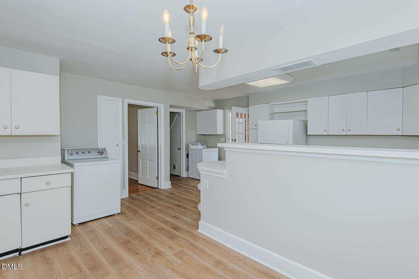 408 Ward Street Graham, NC 27253 - Photo 13 of 21 a view of a kitchen with refrigerator and white cabinets