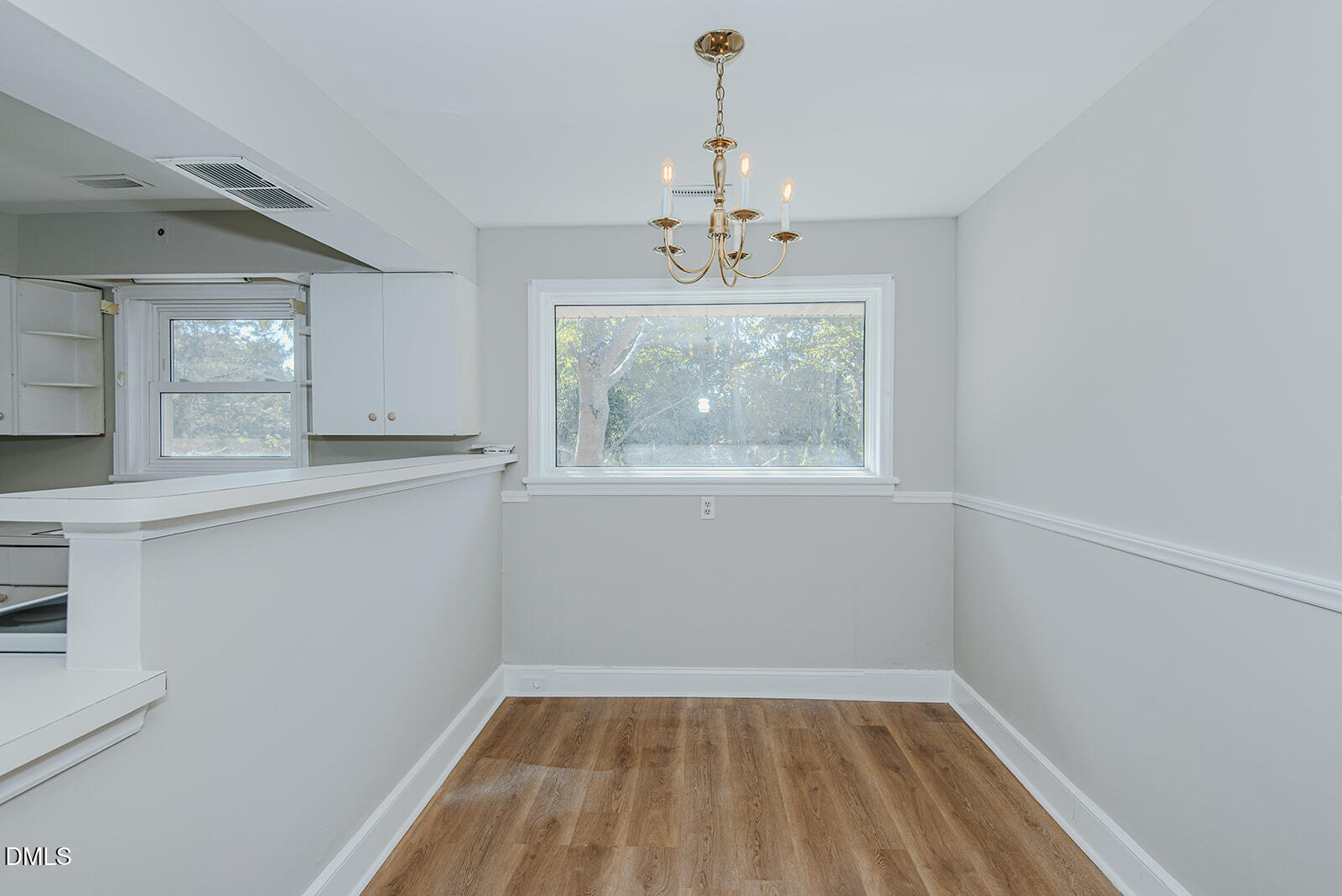 408 Ward Street Graham, NC 27253 - Photo 14 of 21 a view of wooden floor and a chandelier in a room