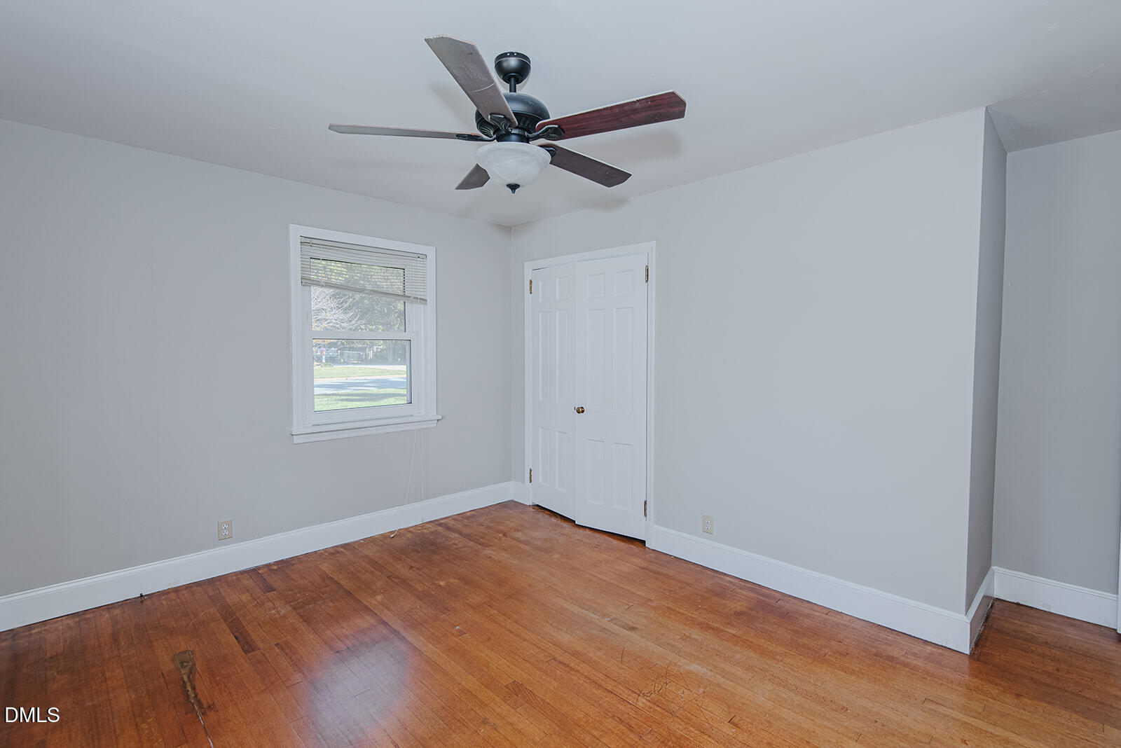 408 Ward Street Graham, NC 27253 - Photo 9 of 21 an empty room with wooden floor ceiling fan and window