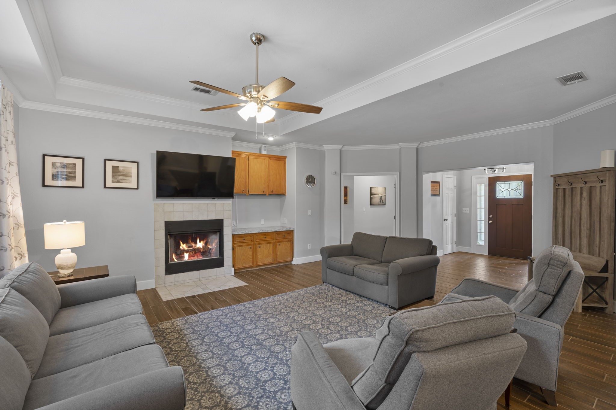 23200 Baneberry Road Magnolia, TX 77355 - Photo 4 of 39 a living room with furniture a fireplace and a flat screen tv