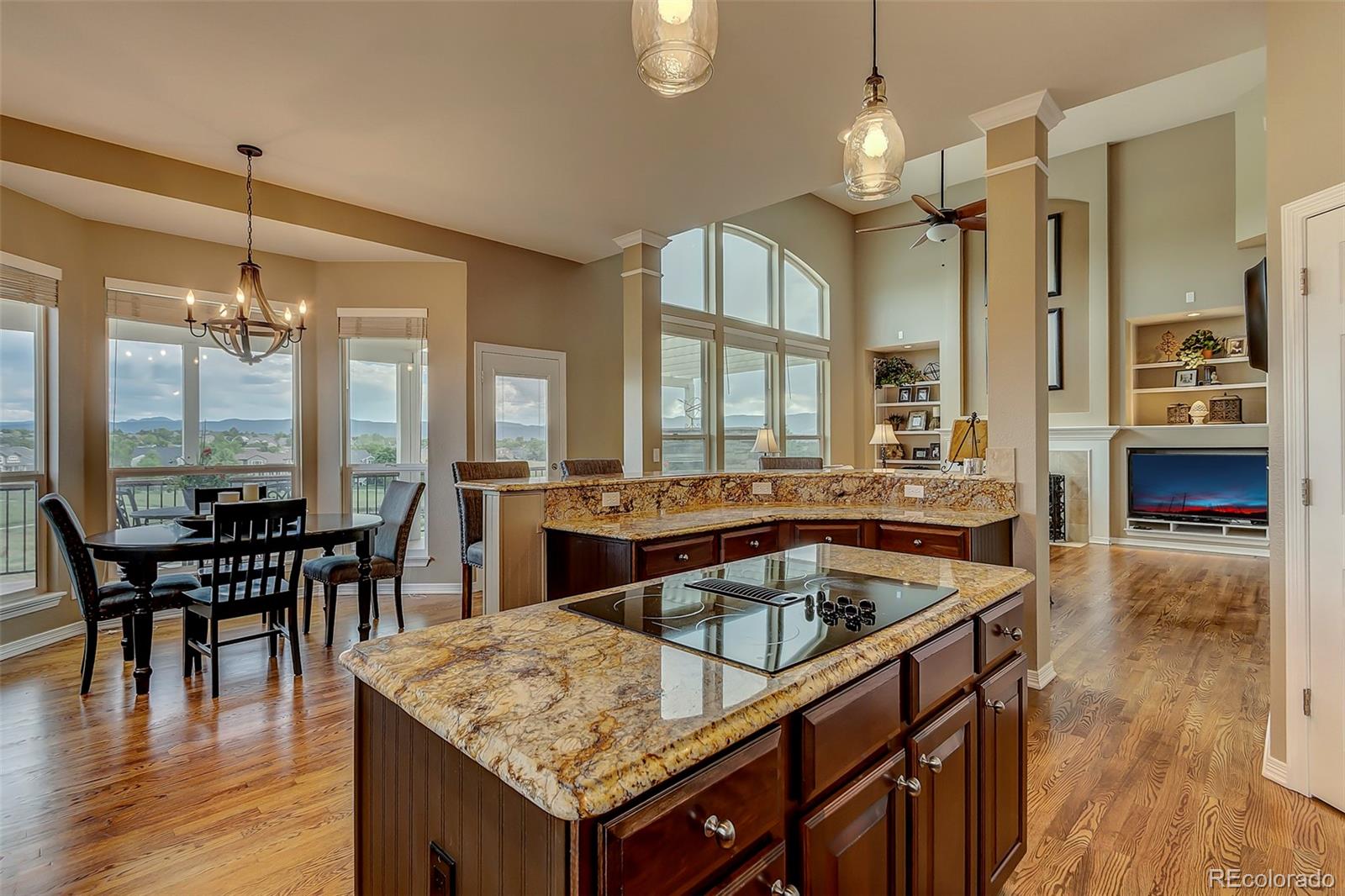 456 West Angus Way Highlands Ranch, CO 80129 - Photo 12 of 40 a kitchen with center island table and chairs