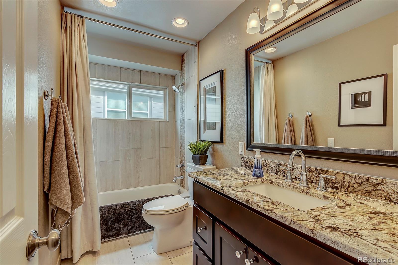 456 West Angus Way Highlands Ranch, CO 80129 - Photo 19 of 40 a bathroom with a granite countertop sink toilet and shower