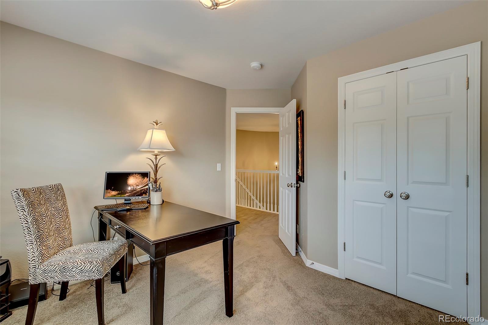 456 West Angus Way Highlands Ranch, CO 80129 - Photo 22 of 40 a view of a workspace with furniture and a lamp