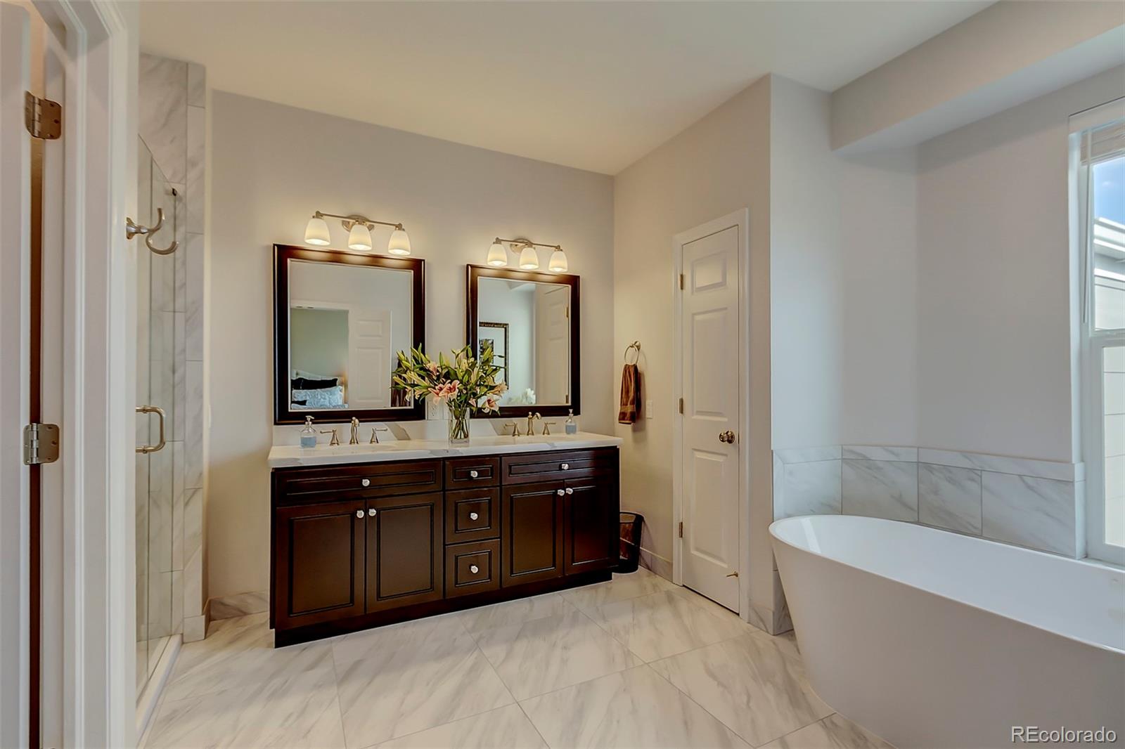 456 West Angus Way Highlands Ranch, CO 80129 - Photo 25 of 40 a spacious bathroom with a tub sink shower and mirror