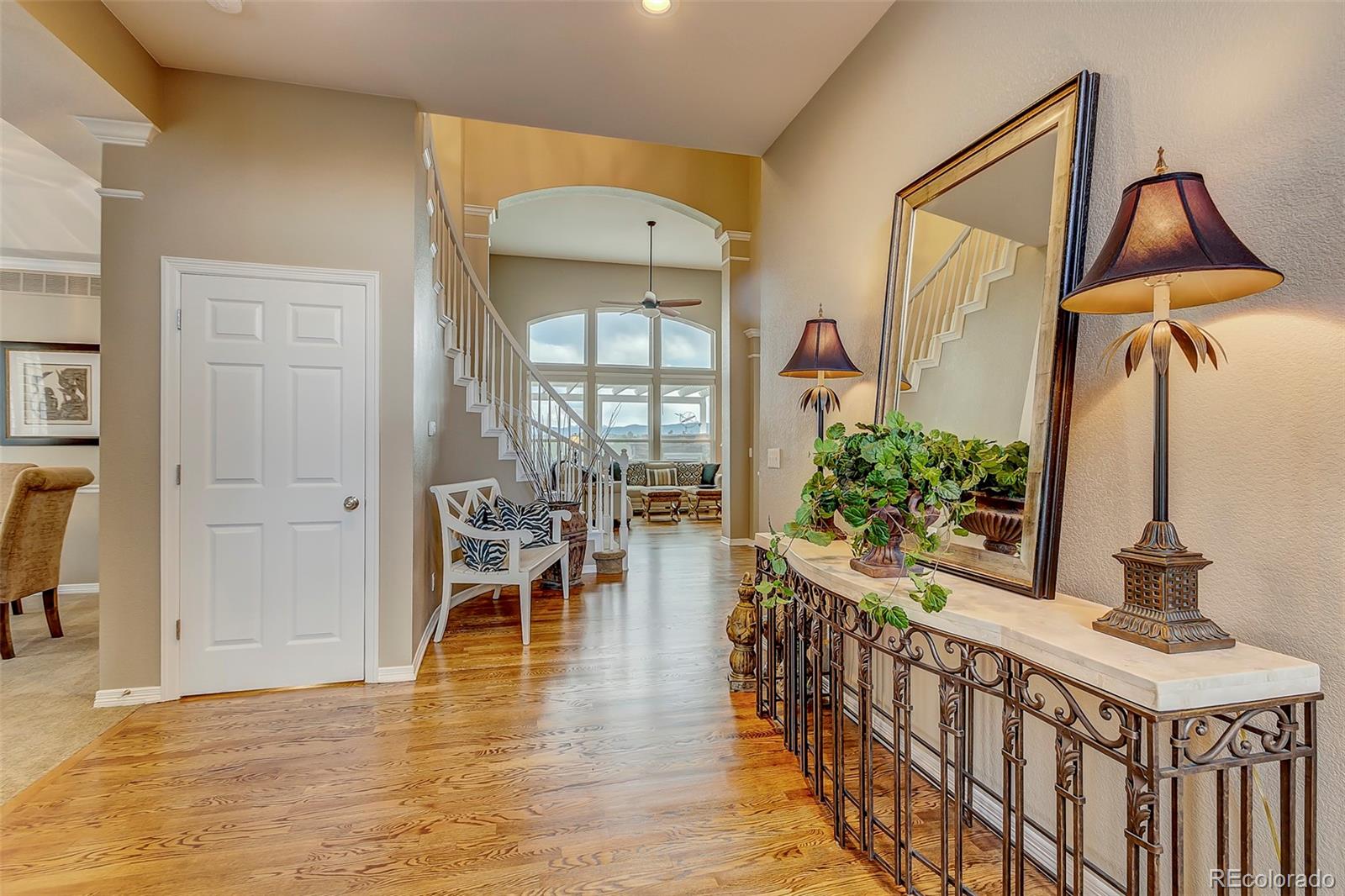 456 West Angus Way Highlands Ranch, CO 80129 - Photo 3 of 40 a dining room with furniture potted plants and wooden floor