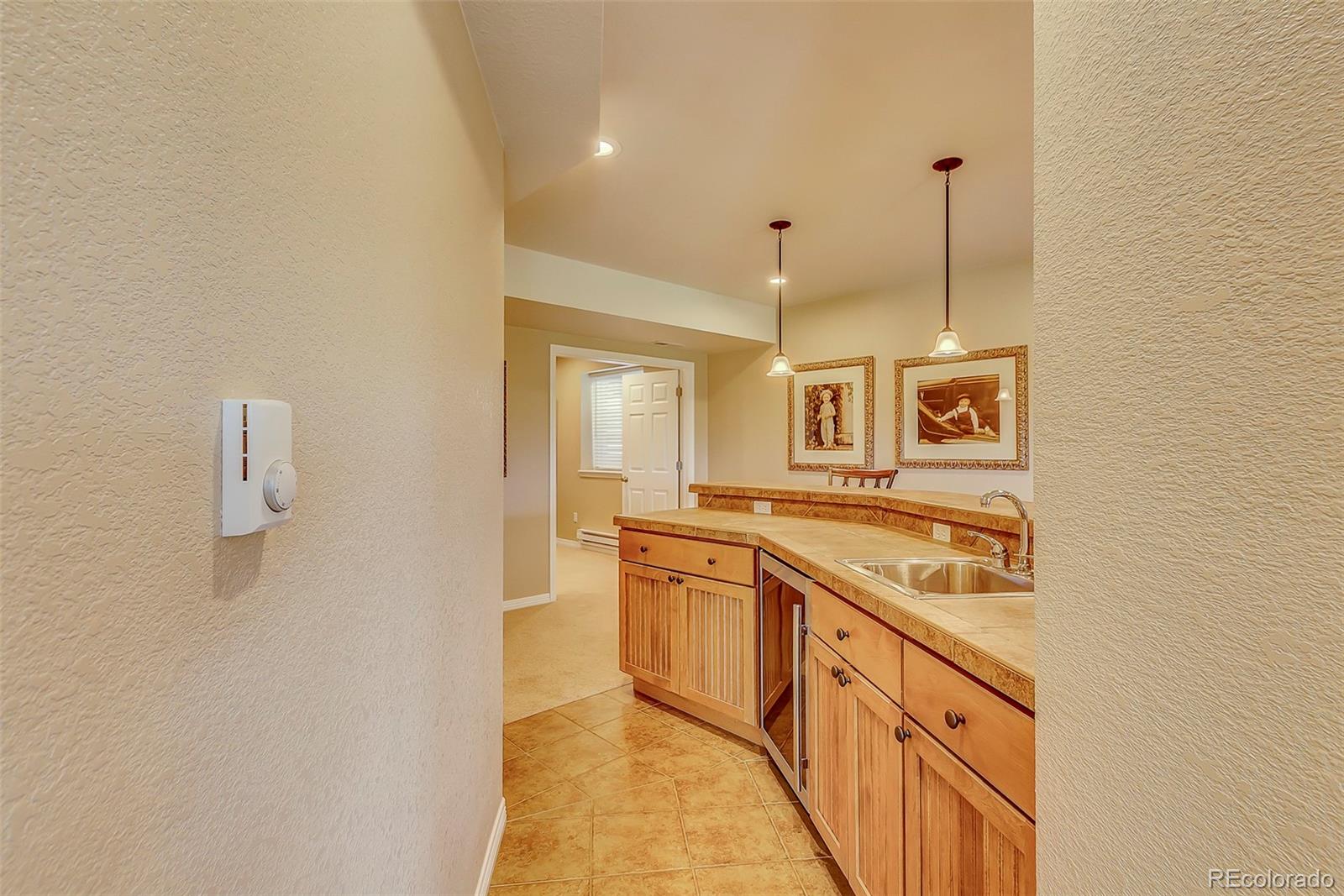 456 West Angus Way Highlands Ranch, CO 80129 - Photo 31 of 40 a kitchen with stainless steel appliances granite countertop a stove a sink and a refrigerator
