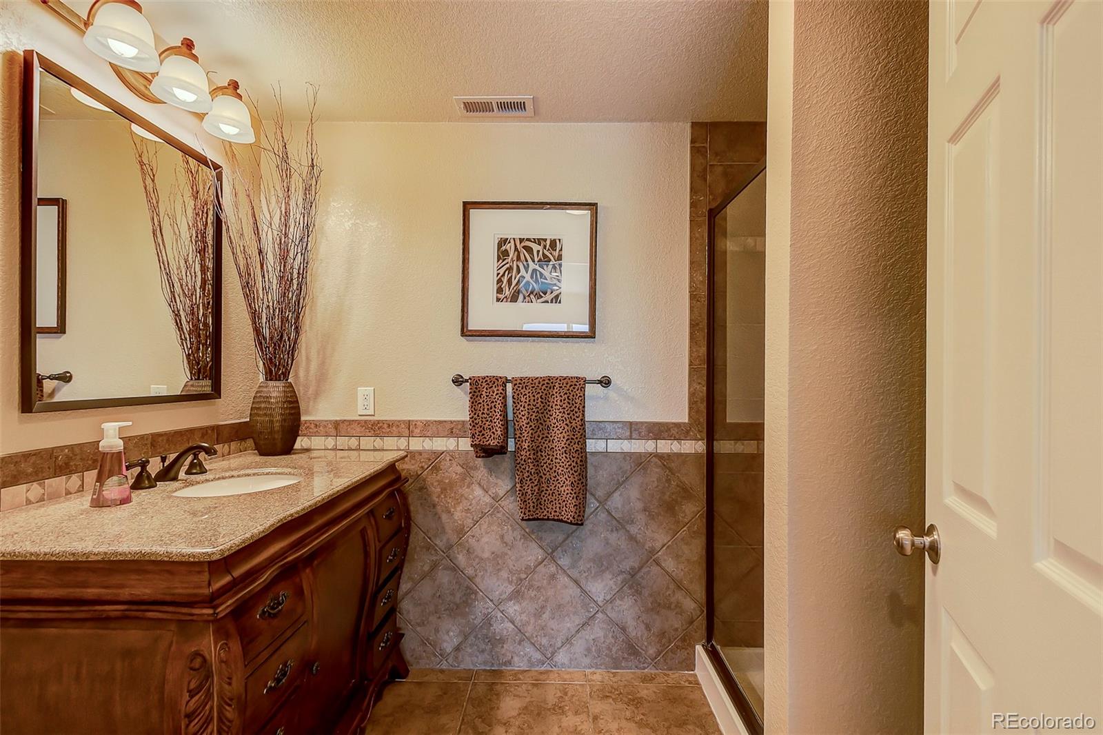 456 West Angus Way Highlands Ranch, CO 80129 - Photo 34 of 40 a bathroom with a sink and a mirror