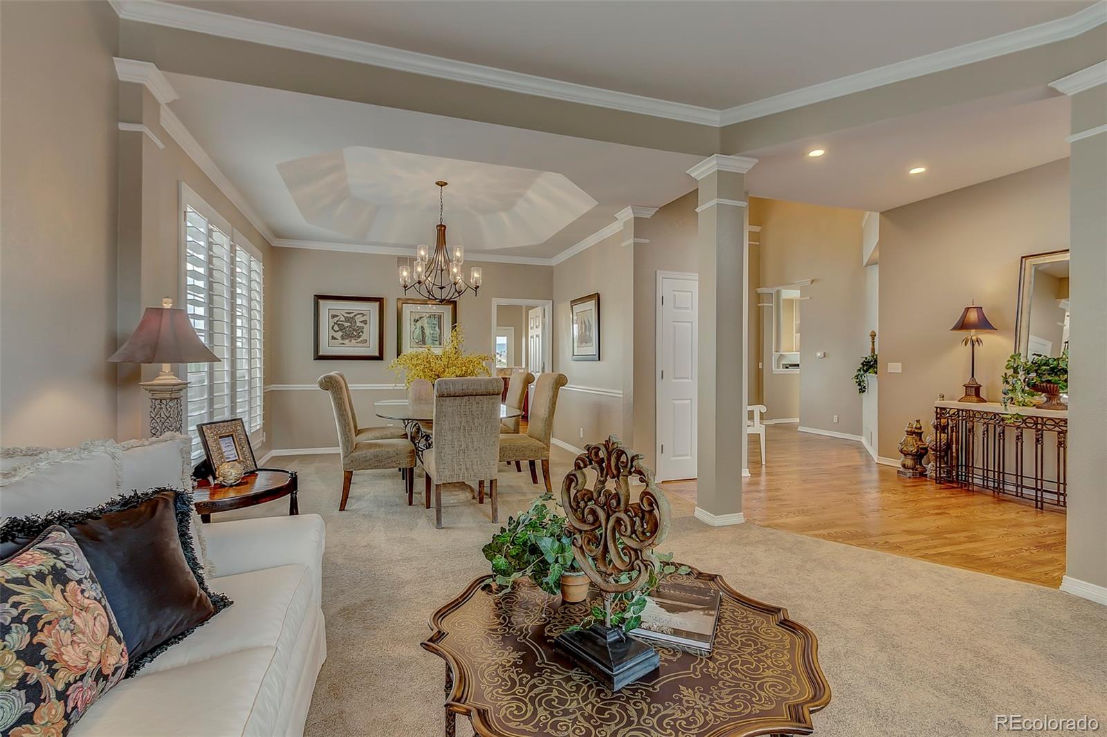 456 West Angus Way Highlands Ranch, CO 80129 - Photo 5 of 40 a living room with furniture and a chandelier