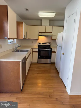 a kitchen with stainless steel appliances a stove and a refrigerator