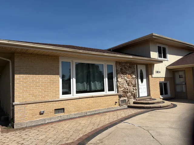 a front view of a house with a floor to ceiling windows