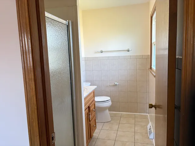 a bathroom with a toilet and shower