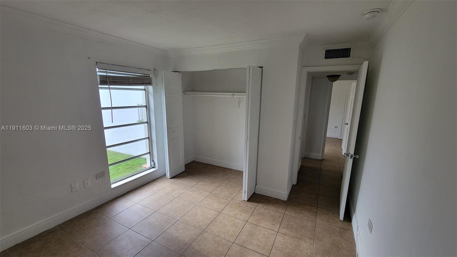 7232 Southwest 94th Place, Unit E7 Miami, FL 33173 - Photo 2 of 10 an empty room with windows
