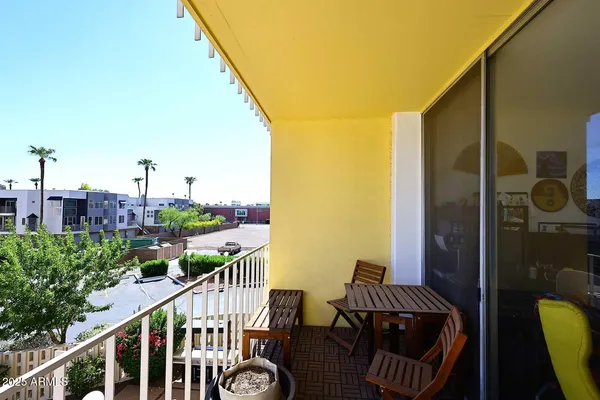 a view of a balcony with furniture
