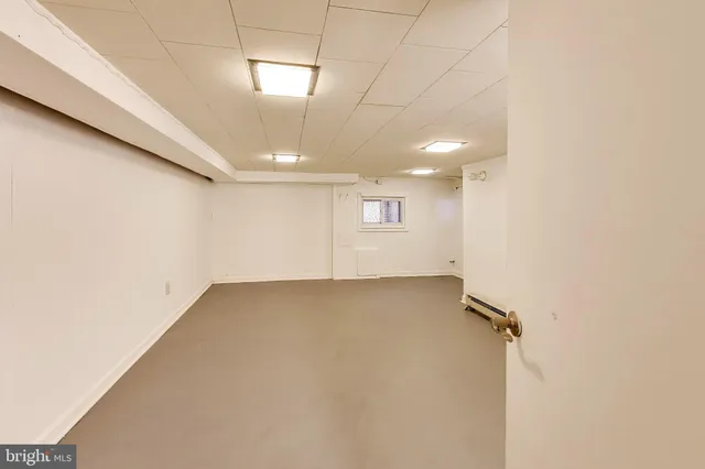 an empty room with a empty space and windows