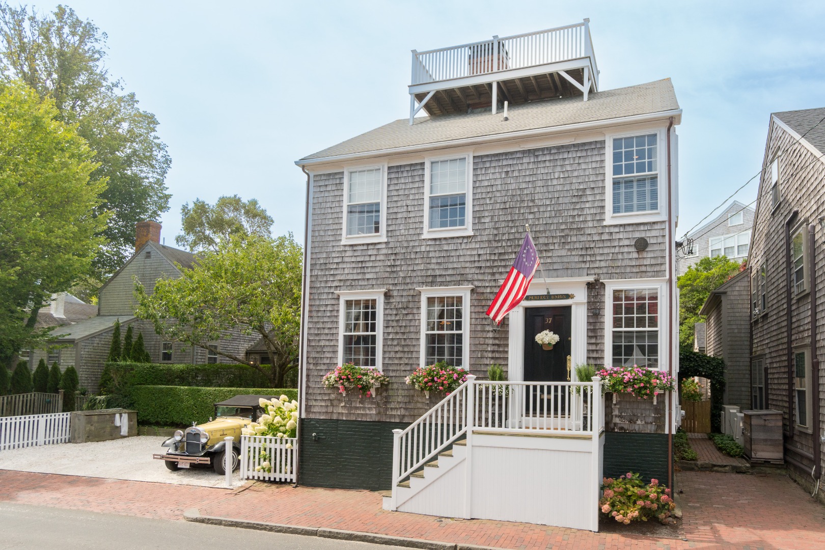 37 Union Street Nantucket, MA 02554 - Photo 1 of 25 a front view of a house with a porch