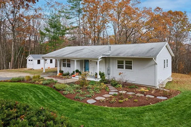 a front view of a house with garden