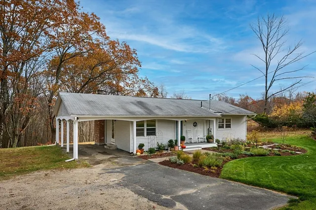 a front view of a house with a garden and outdoor seating