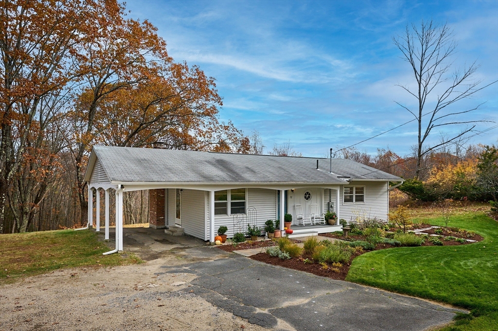 72 North Main Street New Salem, MA 01355 - Photo 2 of 29 a front view of a house with a garden and outdoor seating