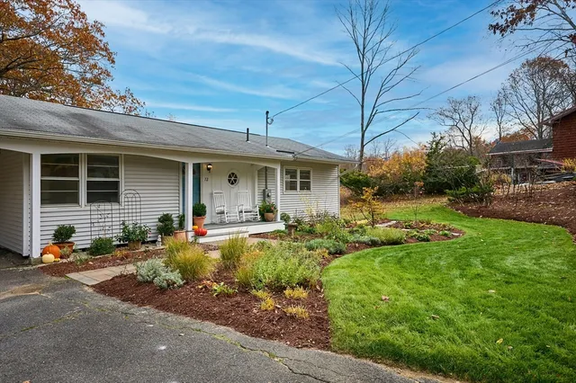 a front view of a house with yard patio and green space