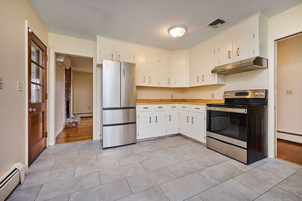 72 North Main Street New Salem, MA 01355 - Photo 8 of 29 a kitchen with stainless steel appliances granite countertop a stove a refrigerator and a cabinets