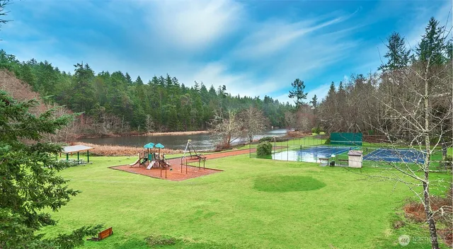 a swimming pool with outdoor seating and yard