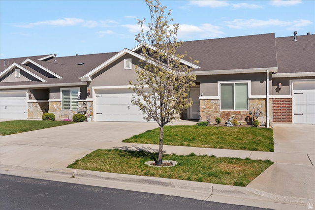 2028 West Grace Way Layton, UT 84041 - Photo 3 of 36 Craftsman inspired home with stone siding, concrete driveway, a front yard, stucco siding, and an attached garage