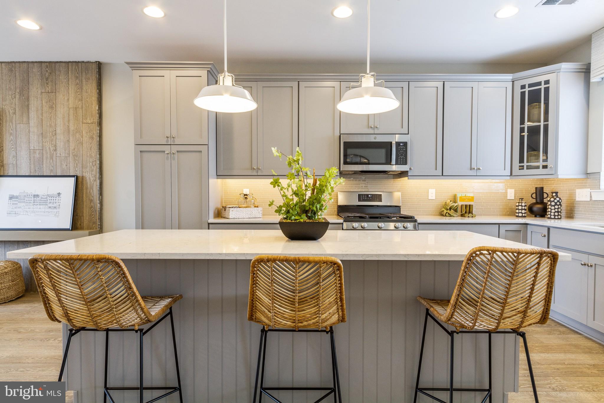 2 Jameson Way, Unit BASE Chalfont, PA 18914 - Photo 15 of 34 a kitchen with stainless steel appliances granite countertop wooden floor cabinets and a chandelier