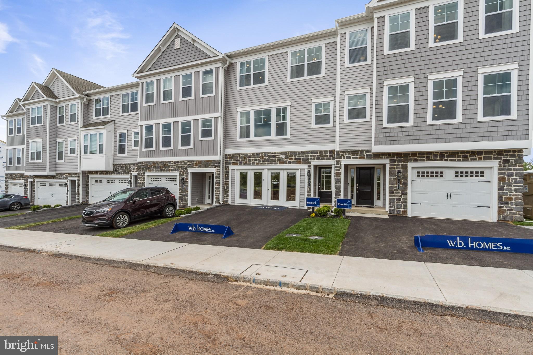 2 Jameson Way, Unit BASE Chalfont, PA 18914 - Photo 4 of 34 a front view of a building with lot of cars and trees