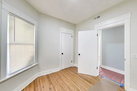 a view of room with window and wooden floor