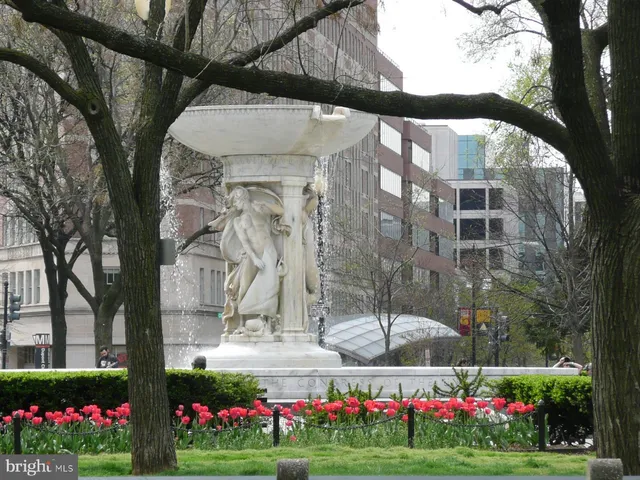 a front view of a building with cars