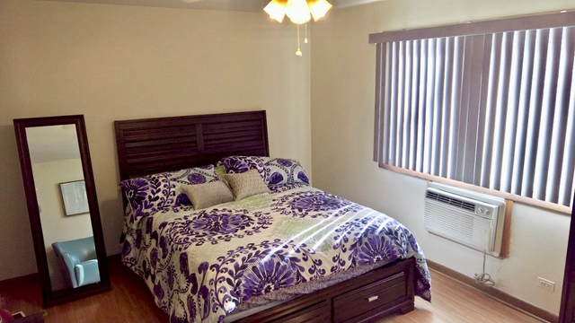 903 Elder Road, Unit 4 Homewood, IL 60430 - Photo 13 of 17 a bedroom with a bed and a chandelier