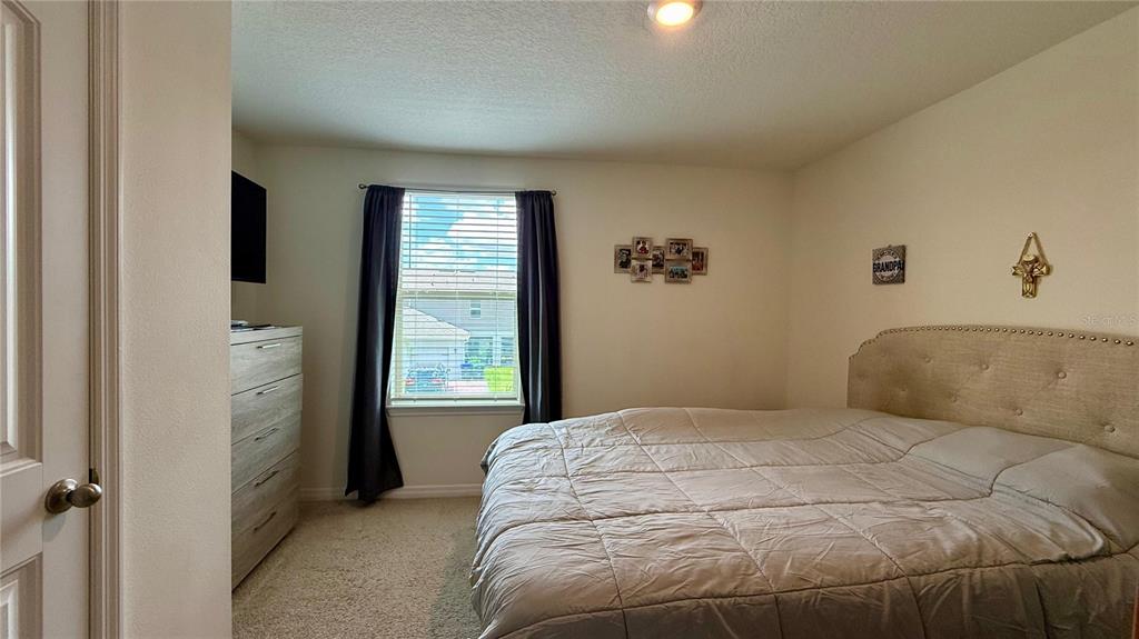 13340 Pontoon Road Winter Garden, FL 34787 - Photo 10 of 15 a bedroom with a bed and a window