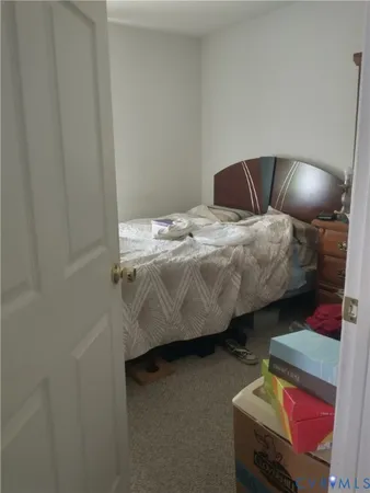 a bedroom with a bed and chair