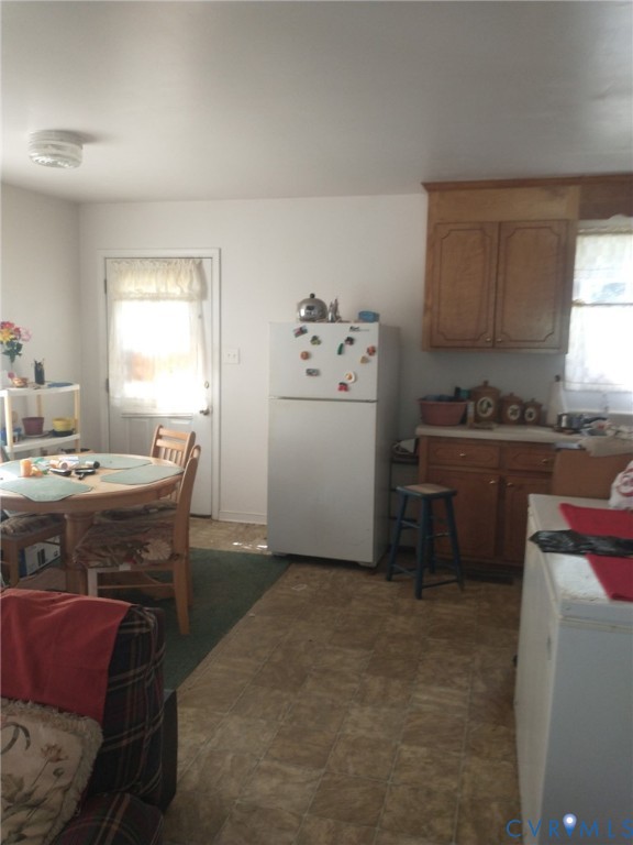 11568 Jerusalem Plank Road Waverly, VA 23890 - Photo 6 of 9 a kitchen with a table chairs sink and cabinets