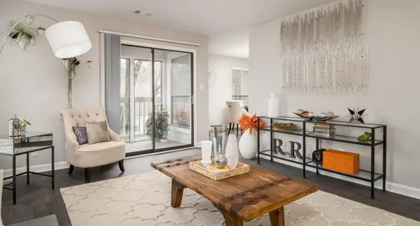 a living room with furniture a rug and a table