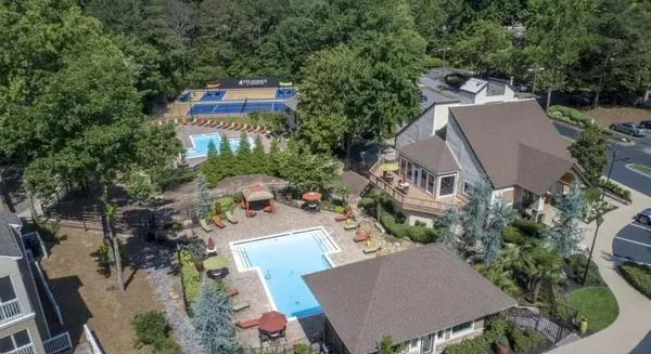 an aerial view of a house with yard and garden