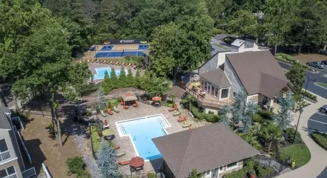 an aerial view of a house with yard and garden