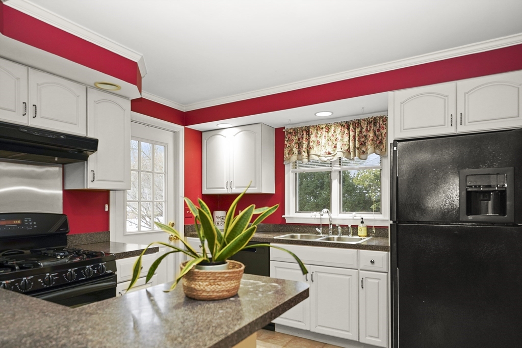 33 Severn Street Longmeadow, MA 01106 - Photo 3 of 42 a kitchen with stainless steel appliances kitchen island granite countertop a stove a sink and a microwave