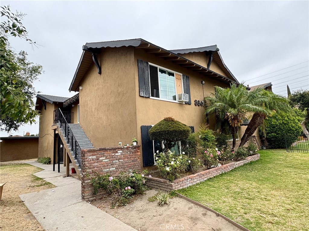 8641 Cerritos Avenue, Unit F Stanton, CA 90680 - Photo 2 of 8 a front view of a house with garden