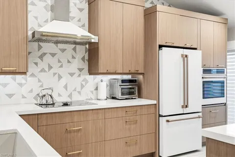 a white refrigerator freezer sitting inside of a kitchen