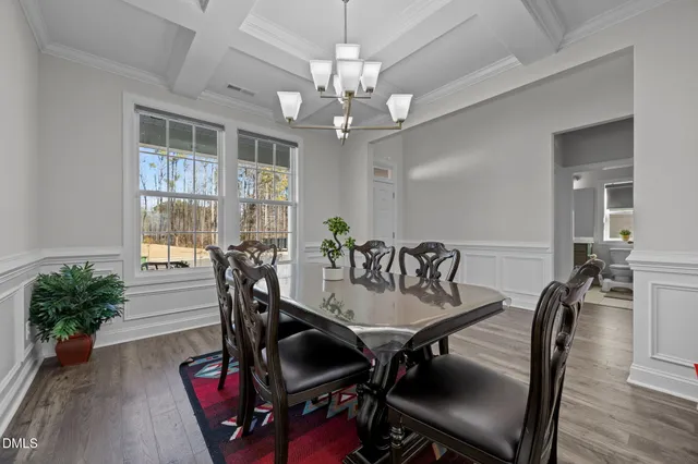 a view of a patio with table and chairs and wooden fence