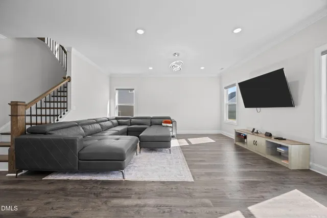 a view of a dining room with hardwood floor and a ceiling fan