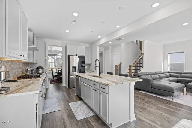 a view of a dining room with furniture a chandelier and wooden floor