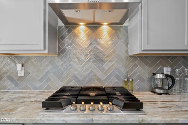 a living room with lots of furniture and kitchen view