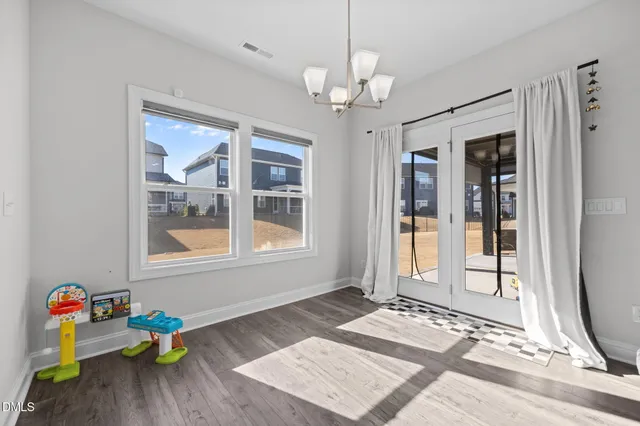 a kitchen that has a lot of cabinets a sink and wooden floor